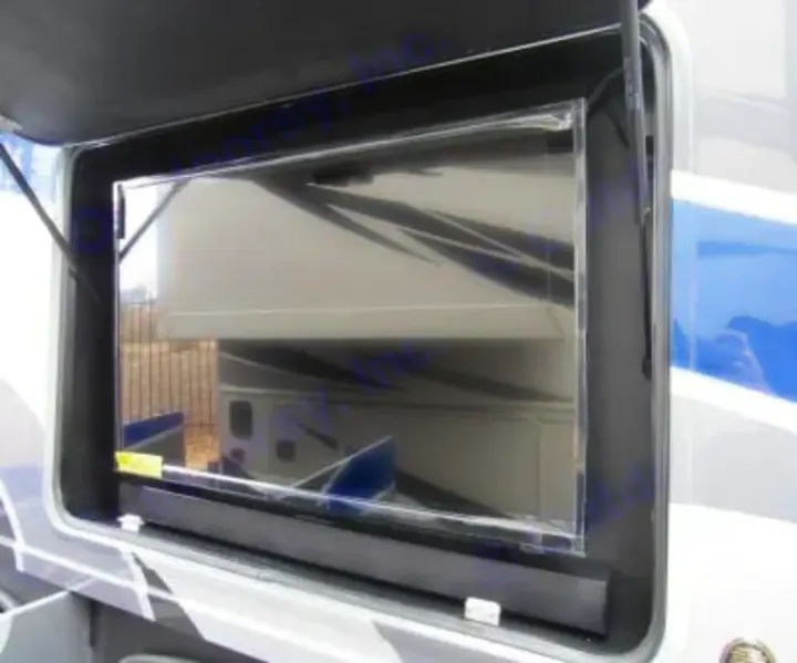 RV rental outdoor entertainment: an open compartment shows a mounted TV and soundbar for exterior viewing.. Thor Miramar 2022