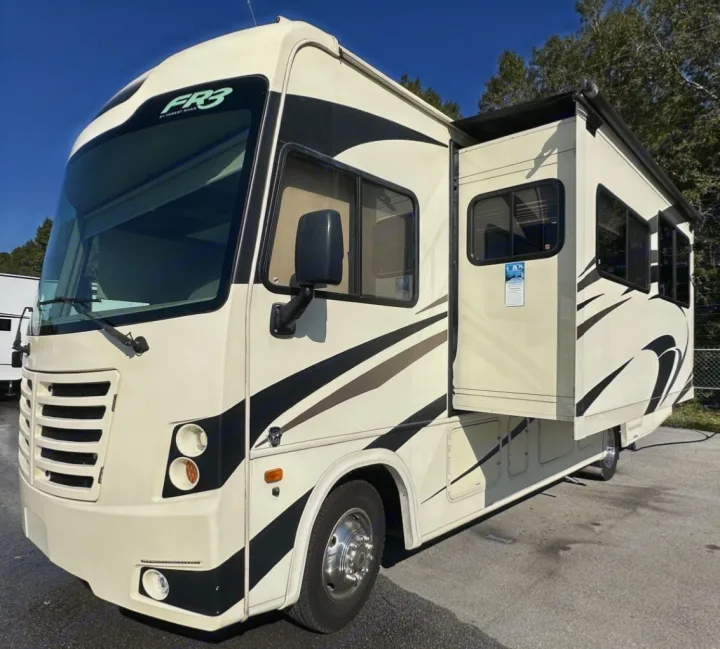 A cream-colored Forest River FR3 Class A motorhome for rv rental, showing its extended slide-out and modern design.. Forest River Fr3 2019
