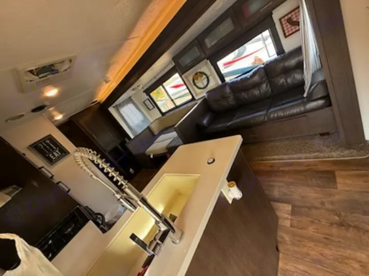 Spacious RV rental interior: modern kitchen with sink, comfortable sofa, and dining area. Enjoy home-like comfort on the road.. Forest River Salem 2019
