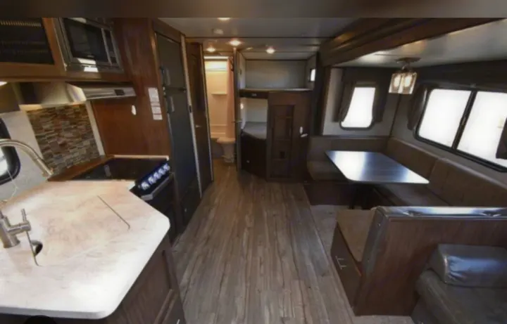 RV rental interior: full kitchen, dinette, bunks, bathroom, living area. Comfortable travel awaits.. Forest River Cherokee Alpha Wolf 2018