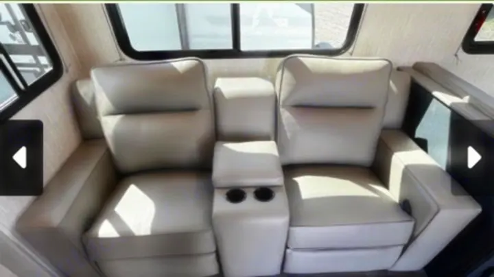 Relax in comfort! Modern RV rental interior with two plush recliners and cup holders for your next adventure.. Coachmen Apex 2024