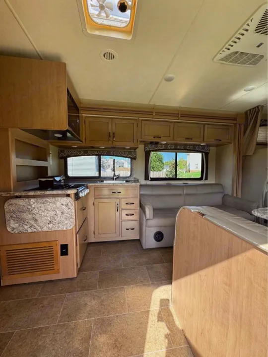 Spacious RV rental interior with a full kitchen, comfy sofa, and tiled floors. Perfect for adventure!. Thor Motor Coach Chateau 2019