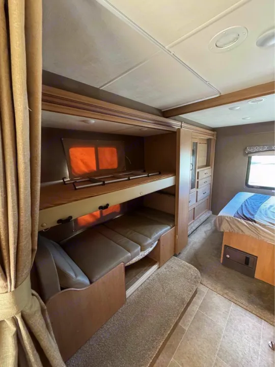 RV rental interior: cozy bunk beds, convertible sofa, & sleeping area for comfort on the road.. Thor Motor Coach Chateau 2019