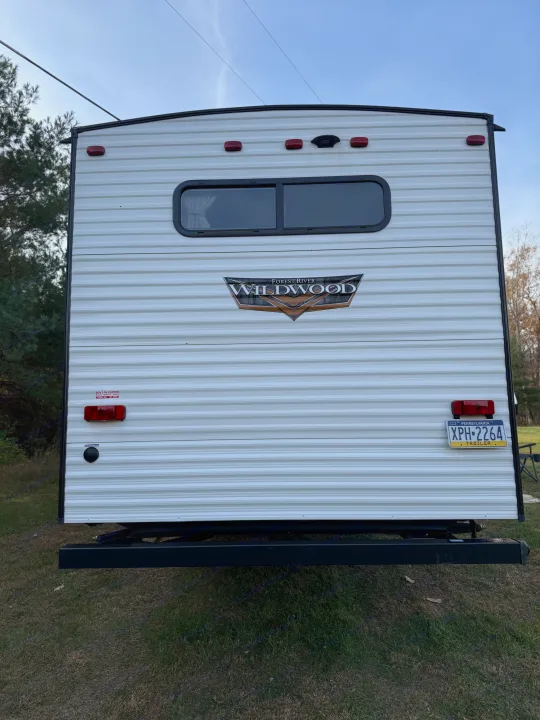 Rear of a white Forest River Wildwood travel trailer (XPH-2264 PA plate), ideal for an RV rental.. Forest River Wildwood 2021