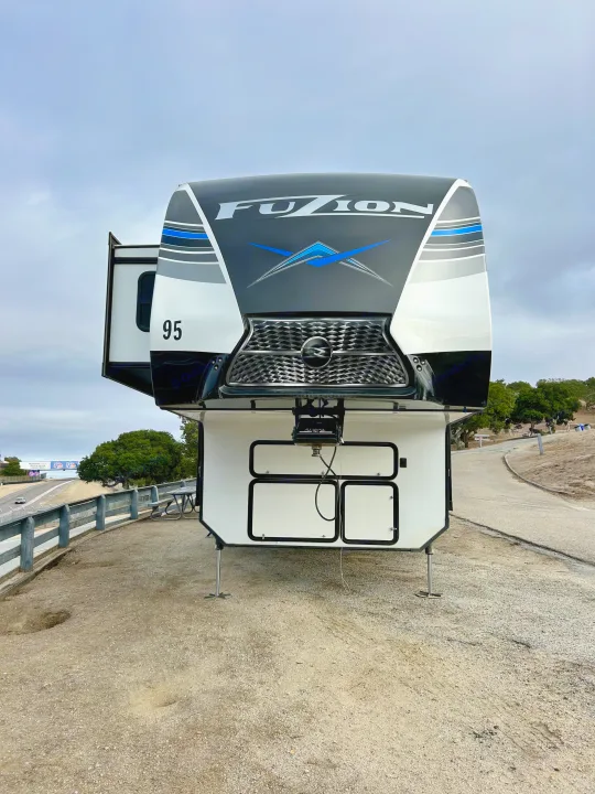 A Fuzion fifth-wheel RV rental #95, parked trackside at WeatherTech Raceway Laguna Seca.. Keystone Fuzion 2022