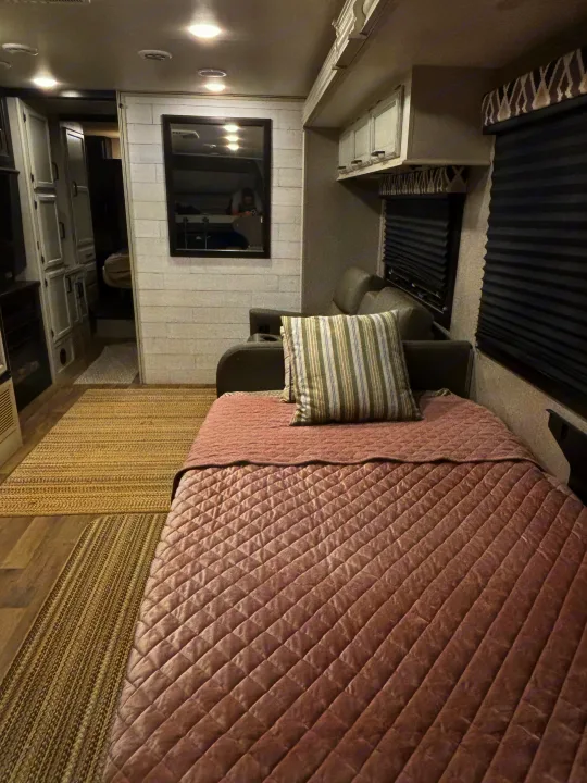 Comfortable RV rental interior features a pull-out bed, sofa, modern decor, and blinds. Perfect for travel.. Entegra Coach Odyssey 2021