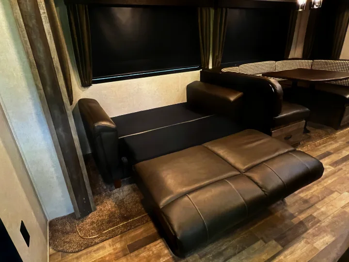 Flexible sleeping in this cozy RV rental: a pull-out sofa bed and dinette with patterned cushions. Ideal for travel comfort.. Forest River Vibe 2020