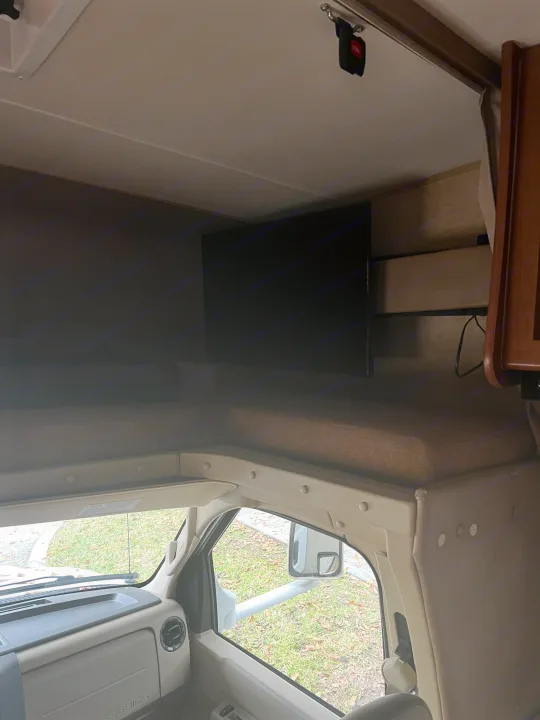 RV rental: Cab-over bunk, TV, and driver's dash. A comfortable space for travel.. Coachmen Leprechaun 2015