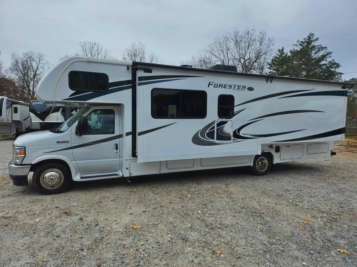 White Class C Forester RV rental motorhome parked on a gravel lot, ready for your next adventure.. Forest River Forester 2021