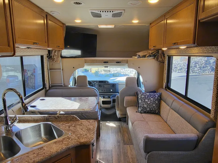 Inside this rv rental: a well-appointed kitchen, dinette, living area with sofa, and overhead bunk. Ready for your adventure.. Thor Freedom Elite 2017