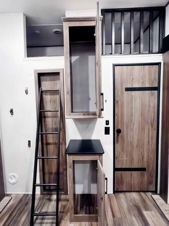 Spacious RV rental interior featuring a ladder to a cozy loft, ample storage, and modern wood finishes.. Heartland RVs Milestone 2021