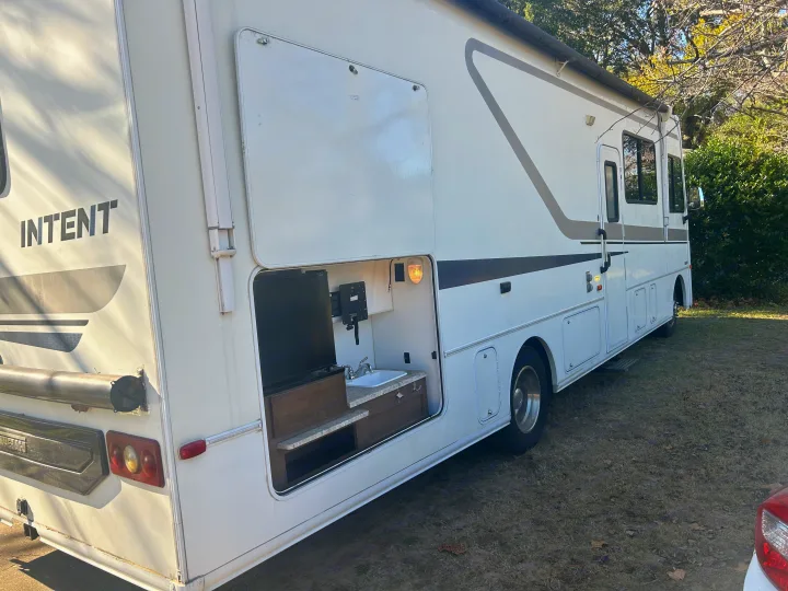 Explore with this 'Intent' RV rental, featuring an outdoor kitchen with sink, mini-fridge, and TV mount for your next travel adventure.. Winnebago Intent 2018