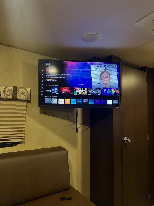 A Vizio smart TV with streaming apps (Netflix, Hulu) mounted in an rv rental, offering entertainment in a compact space.. Forest River Cherokee Grey Wolf 2016