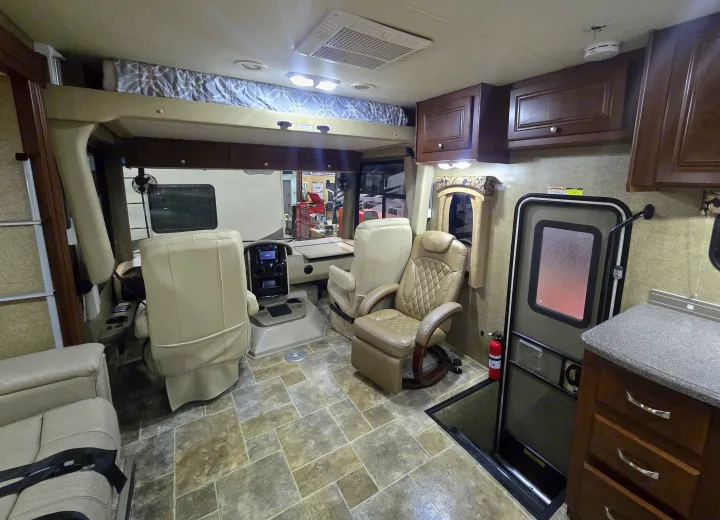 Explore this RV rental's spacious interior: cockpit, cab-over bed, comfortable seating, and home-like amenities.. Thor Motor Coach Miramar 2014