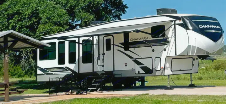 This Chaparral fifth-wheel RV rental is perfectly set up at a scenic campsite, ready for your next camping adventure.. Coachmen Chaparral 2022