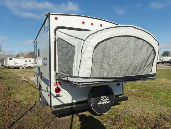 An RV rental, this Jayco travel trailer has its rear pop-out tent bed extended, ready for camping.. Jayco Jay Feather 2018