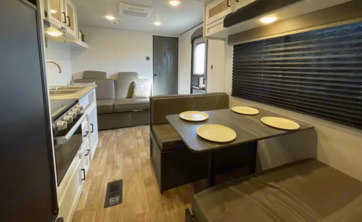 Spacious RV rental interior: modern kitchen, cozy dinette, and living area. Perfect for travel!. Keystone RV Hideout 2023