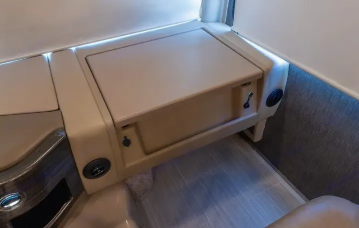 RV rental: Modern interior featuring a versatile console with a stowed table, storage, power outlets, and accent lighting.. Thor Challenger 2021