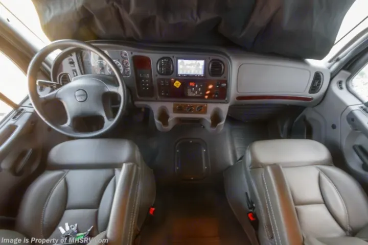RV rental: Interior shot of the driver's area, showing the dashboard, steering wheel, and two leather front seats.. Entegra Coach Accolade 2023