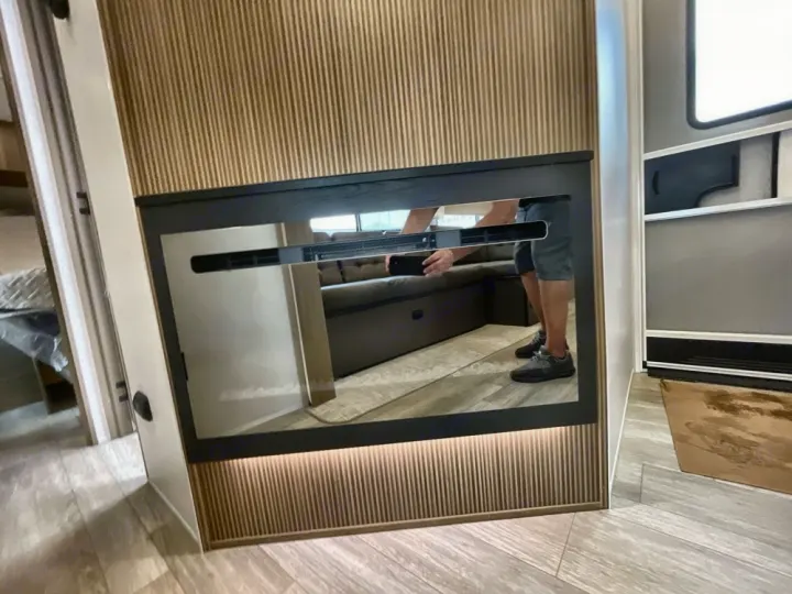 Explore a modern RV rental interior featuring a stylish electric fireplace reflecting the comfy living space.. Forest River Salem 2025
