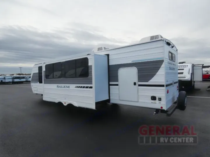 Spacious white Salem travel trailer RV rental with slide-out parked at a dealership lot.. Forest River Salem 2025