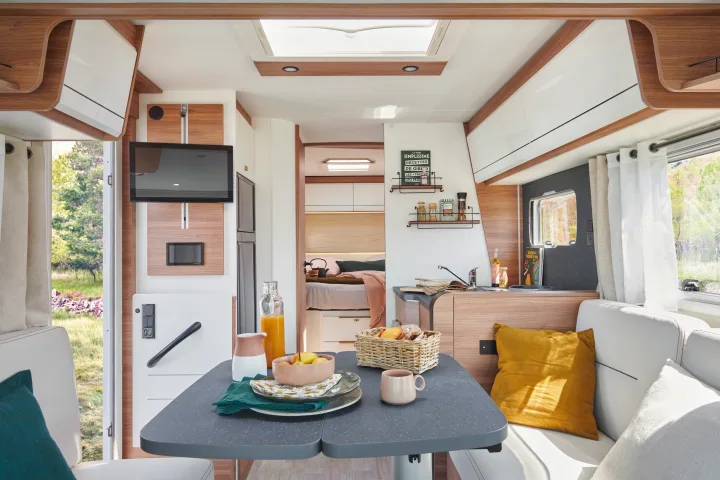 Spacious RV interior with dining, kitchen, and bedroom areas, perfect for your next rv rental adventure.. Pilote G740FC EVIDENCE 2025