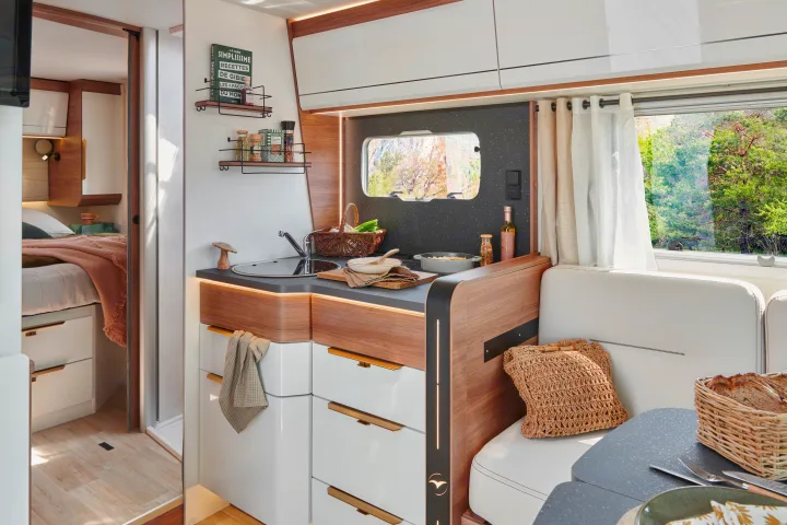 Bright and modern RV rental interior featuring a functional kitchen, cozy bedroom, and dining space for comfortable travel.. Pilote G740FC EVIDENCE 2025