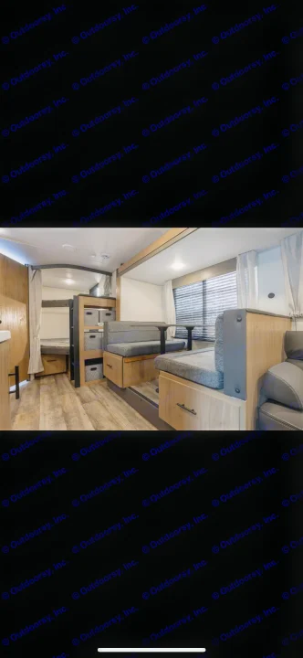 Spacious RV rental interior with bunk beds, a dinette, and wood-style flooring, perfect for comfortable camper travel.. Forest River Campsite Reserve 2025