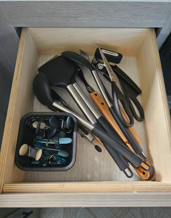 RV rental kitchen drawer stocked with spatulas, tongs, scissors, can opener, and clips. Compact and organized. Forest River Salem 2024