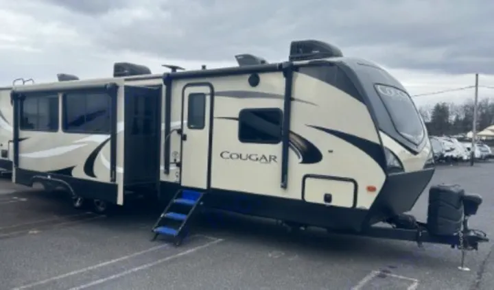 Spacious cream and black Cougar travel trailer RV with slide-outs, ready for your next rv rental adventure.. Keystone RV Cougar 2019