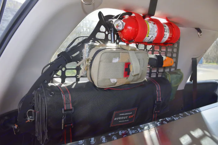 Secure RV rental gear: fire extinguisher, first-aid kit, & Overland Solar bag mounted on a vehicle cargo panel.. Toyota 4Runner 2021