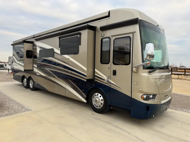 Luxury Newmar Ventana motorhome RV rental. Extended slide-outs enhance spacious living, parked on concrete.. Newmar Ventana 2020