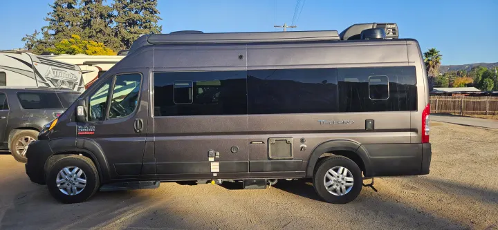 Grey Thor Tellaro camper van for rv rental. Parked outside with other RVs, ready for your next adventure.. Thor Tellaro 2022