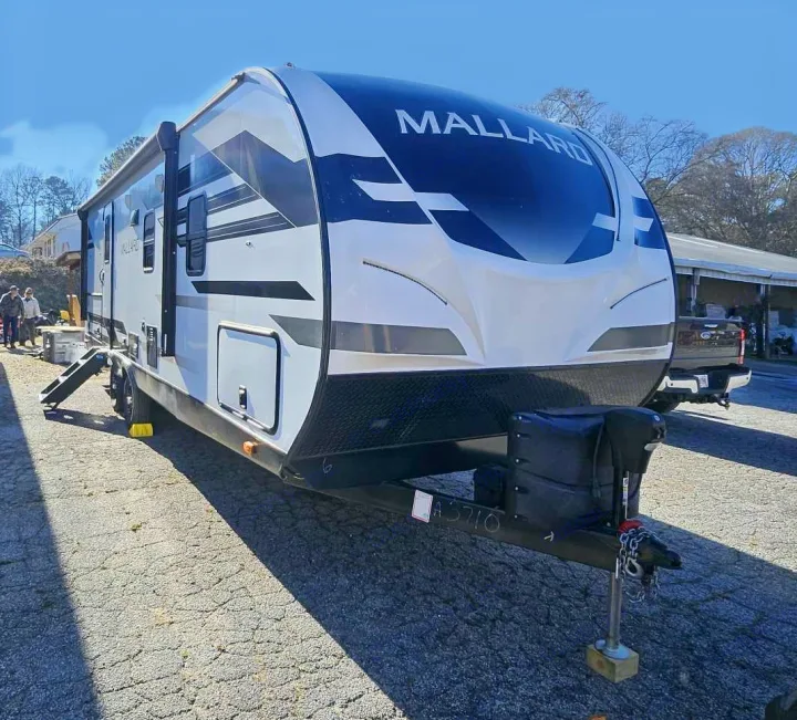Sleek white & black Mallard travel trailer, ideal for an RV rental. Ready for camping and outdoor adventures.. Heartland mallard 2022