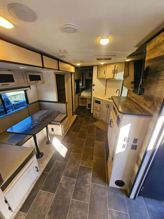 Spacious and modern RV rental interior with a dinette, kitchen, and cozy living space, ideal for your next adventure.. Heartland mallard 2022