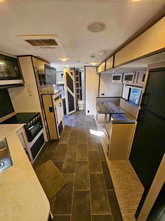 Modern RV rental interior with full kitchen, dinette, and ample living space. Perfect for comfortable travels.. Heartland mallard 2022