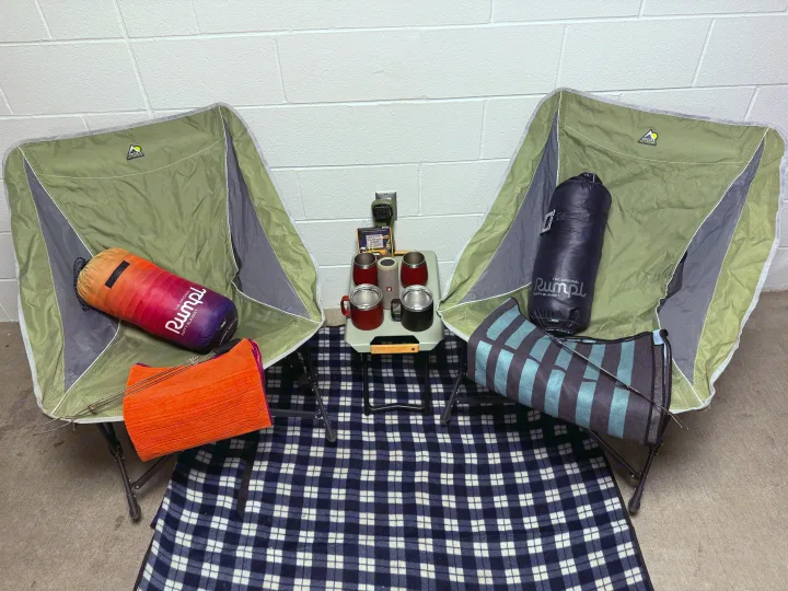 Cozy rv rental setup with two camping chairs, Rumpl puffy blankets, a plaid throw, and essentials for outdoor comfort.. Toyota Tacoma TRD-Pro 2020