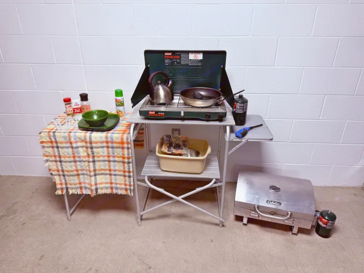 This complete portable camping kitchen, featuring a Coleman propane stove, Cabela's grill, and utensils, is ideal for any RV rental.. Toyota Tacoma TRD-Pro 2020