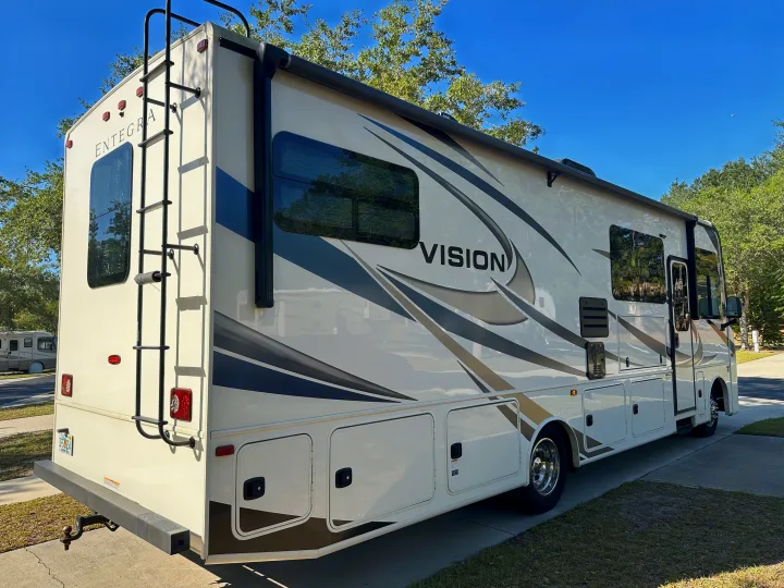 A spacious Entegra Vision Class A motorhome, perfect for an RV rental adventure, parked on a sunny day.. Entegra Coach 29F 2021