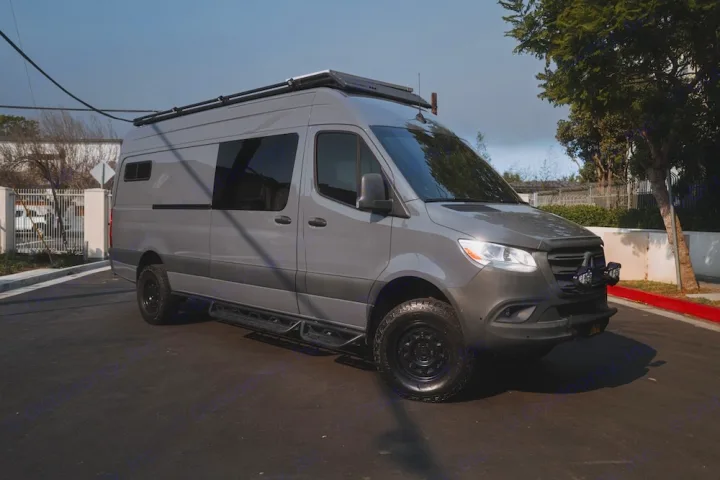 Stylish gray Mercedes Sprinter camper van for RV rental, ready for adventure. Features off-road tires & roof rack.. Mercedes-Benz Sprinter 2022