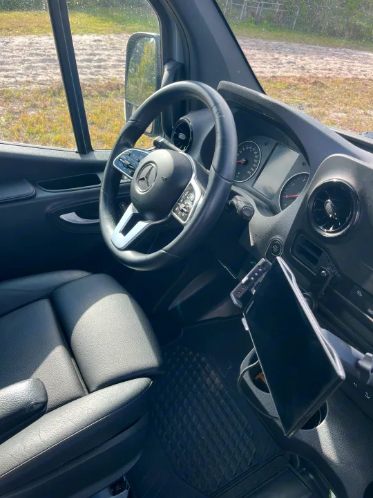 RV rental interior: Mercedes-Benz driver's seat, steering wheel, and dashboard with a Garmin navigation device.. Mercedes benz Sprinter 2022