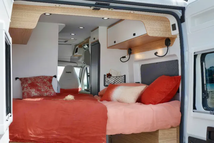 A comfortable rv rental camper van interior, showcasing a cozy bedroom with two beds, overhead storage, and reading lights.. Pilote V600G EVIDENCE 2025