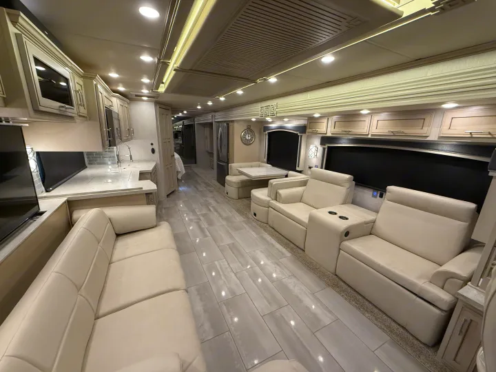 Inside a luxurious rv rental, featuring a spacious living area, modern kitchen, and comfortable recliners for premium travel.. Newmar Ventana 2020