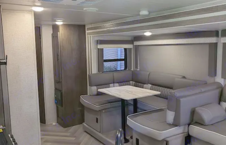 RV rental's U-shaped dinette area, with comfortable seating, a table, and modern design, ready for your adventures.. Forest River Salem Cruise Lite 2021