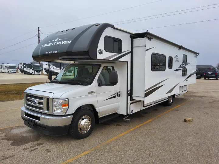 White Forest River East to West Entrada Class C RV, perfect for RV rental, parked on an outdoor lot.. East To West Entrada 2025