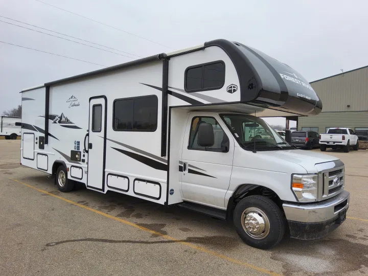Modern white Class C RV rental, a Forest River East & West Entrada motorhome, parked on asphalt.. East To West Entrada 2025