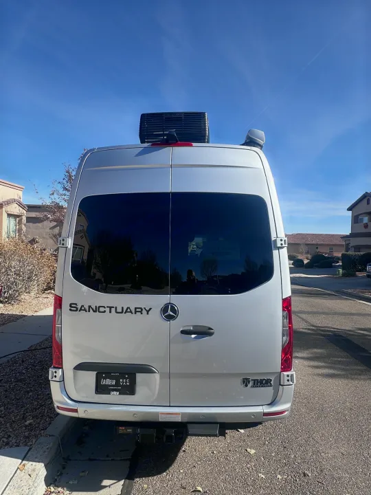Rear view of a sleek silver Thor Sanctuary Mercedes-Benz camper van, ideal for an rv rental adventure.. Thor Sanctuary 19P 2025