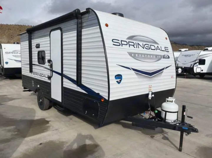 This white Springdale travel trailer RV, with black and blue accents, is ready for your next rv rental adventure.. Keystone RV Springdale 2024