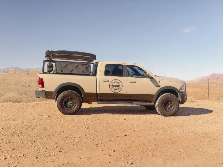 A beige and black overland truck with a rooftop tent, perfect for an off-road RV rental expedition.. Dodge Dodge 1 Ton Pu 2018