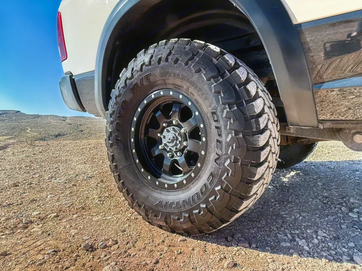 Close-up of a rugged off-road tire on an RV rental truck, ready for desert adventures on rocky terrain.. Dodge Dodge 1 Ton Pu 2018